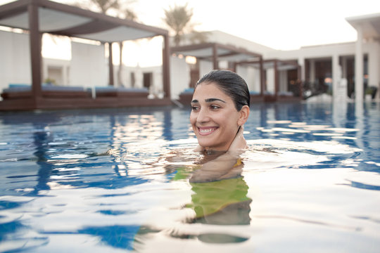 Expat woman in swimming pool.