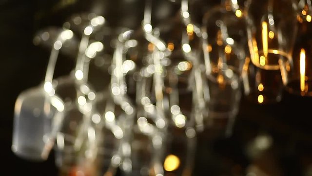 Shot of glasses hanging in a bar with focus transition.