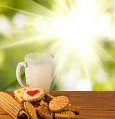many delicious cookies and milk on the table close-up.