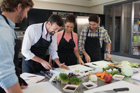 Chef chopping vegetable in the kitchen.
