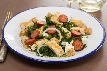 salad with grilled chicken and smoked sausage on plate