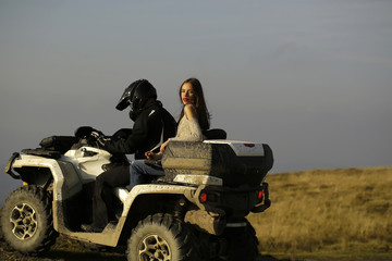 Man and girl ride quad