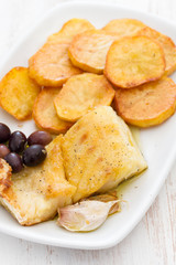 fried cod fish with potato on white dish