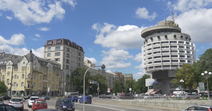 Intensive Traffic and Numerous Green Trees on Slava Square With a Nonstandard and Modern Looking Saljut Hotel the Center of Children Creativity