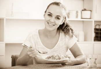 girl with chestnut hair eating porridge