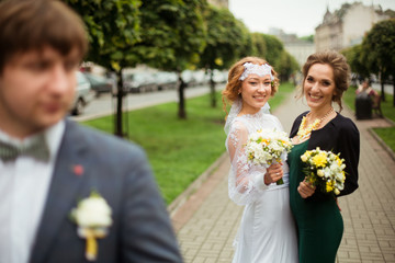 nice portrait of beautiful bride and her charming bridesmaid
