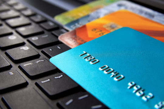 Closeup view of credit cards on laptop keyboard. online shopping