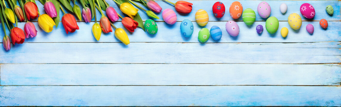 Easter Eggs And Tulips On Blue Wooden Plank
