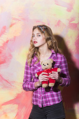 Pretty girl with cute teddy bear in red