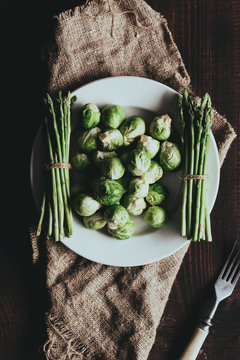 Table Served Rustic Style With Raw Green Asparagus And Brussel Sprouts Top View