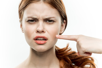 Fototapeta premium emotional woman shows a finger to the side