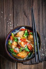 Spicy noodle with vegetables, chicken and chili peppers