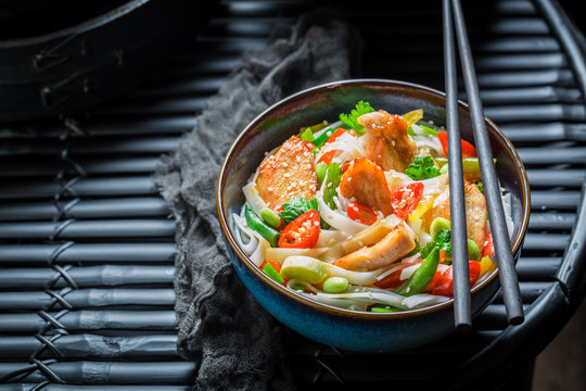Tasty noodle with vegetables, chicken and chili peppers