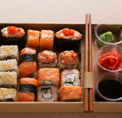 Set of sushi maki and rolls closeup in carton delivery box