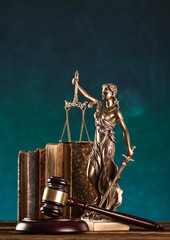 brown gavel with statue of justice.