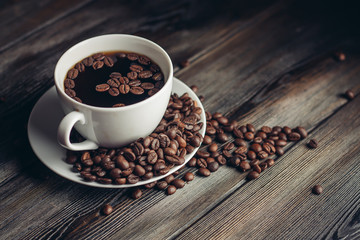 a cup of coffee with coffee beans