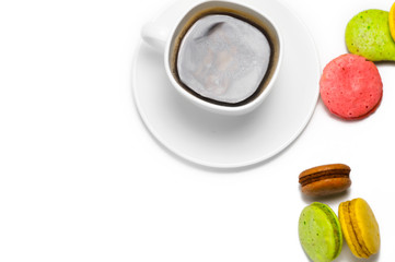 Coffee and colorful macaron on a white background. Isolated