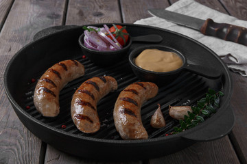 homemade grilled sausage with spices on grill