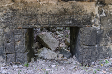 detail of the reliefs and glyphs of a Mayan temple in ruins in the archaeological Sayil enclosure in Yucatan, Mexico