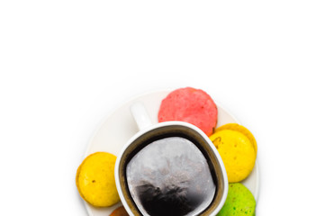 Coffee and colorful macaron on a white background. Isolated