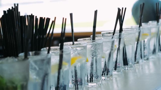 Fresh alcoholic cocktails on the bar. Camera motion.