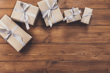 Presents in gift boxes on wood frame background