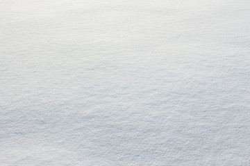 Fresh snow texture on winter ground. Horizontal color image of beautiful white natural background of snowy clean surface.