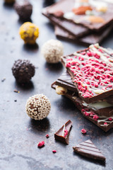 Fototapeta premium Stack of chocolate bars and praline truffle