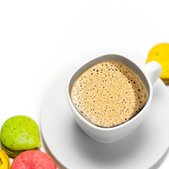 Coffee and colorful macaron on a white background. Isolated