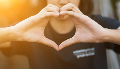 Hand of female in shape of heart for love,soft focus.
