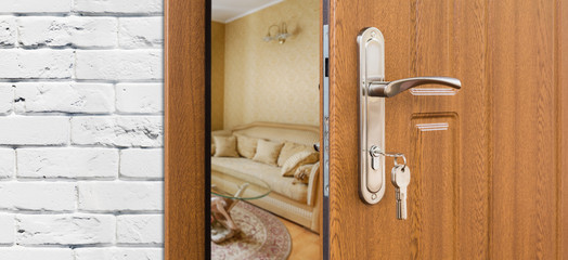 Fototapeta premium Half open door of a modern living room closeup.