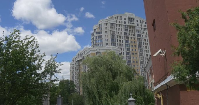 Multistoreyed Buildings on Slava Square in Kiev, With a Lot of Green Trees and Impressive Cloudscape in Summer