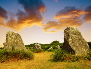 Megalithic monuments menhirs in Carnac at sunset - Brittany, France
