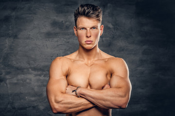Fototapeta na wymiar Shirtless muscular male on grey background.