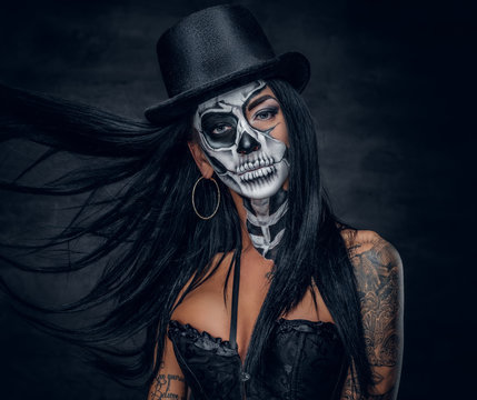 A woman with painted skull face.