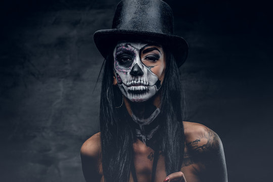 A woman with painted skull face.