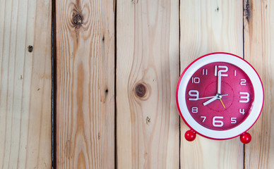 Clock on wooden background,selective focus.
