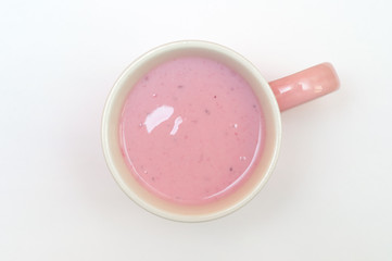 Yogurt with bilberry and blackberry in pink cup. Milk product is