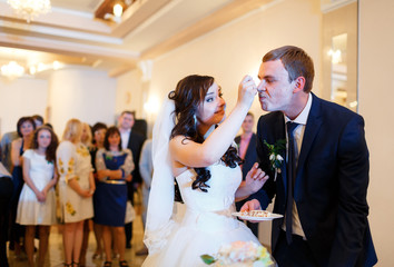 Bride feeds the groom wedding cake