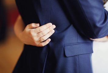 The bride hugging groom