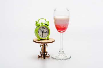 alcohol coctail singapore sling with clock on decorative table