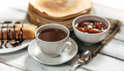 Delicious breakfast. Homemade Pancakes or blini with chocolate cream and cup 