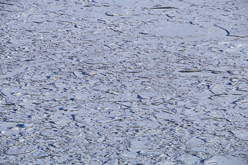 Ice shards on the river, covered with snow.