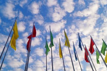 Colorful flag under the blue sky and white clouds, very beautiful.