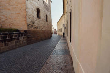 Man walking on the ancient streets with gray paving stones