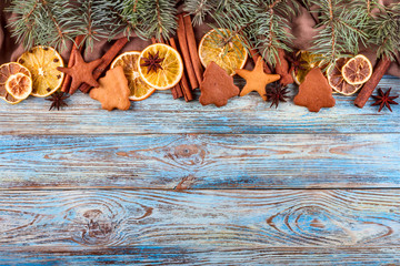Dried oranges, star anise, cinnamon sticks and gingerbread on a blue wooden background -- Christmas still life background