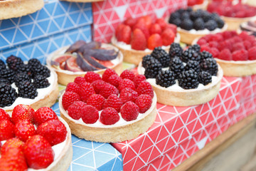 Fruit and berry tarts dessert tray assorted outdoors