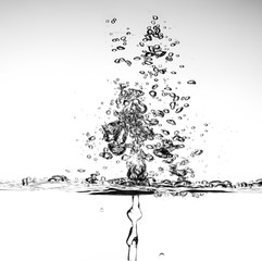 splashing water with bubbles on white background closeup