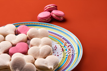 Pink and cream macaron on orange background