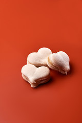 Cake macaron or macaroon on orange background